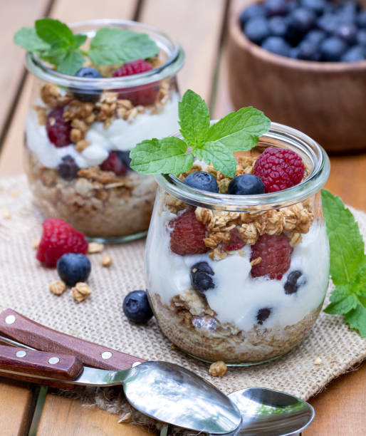 istock Yogurt parfait with granola, blueberries and raspberries garnished with mint 1587383457
