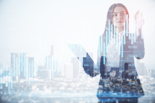 Successful young businesswoman silhouette using forex chart hologram on blurry city background with mock up city view. Future and financial freedom concept. Double exposure
