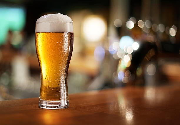 Glass of light beer. Glass of light beer on a dark pub. beer glass stock pictures, royalty-free photos & images