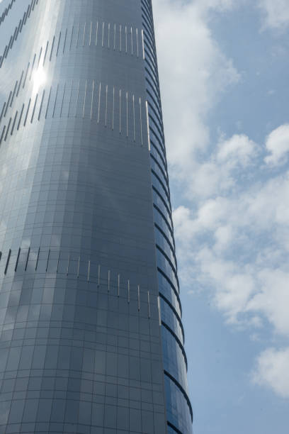istock Skyscraper commercial building glass windows on cloudy sky 1587412025