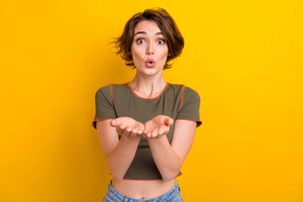 Photo of excited flirty girl dressed khaki top sending arms holding kiss isolated yellow color background Photo of excited flirty girl dressed khaki top sending arms holding kiss isolated yellow color background. puckering stock pictures, royalty-free photos & images