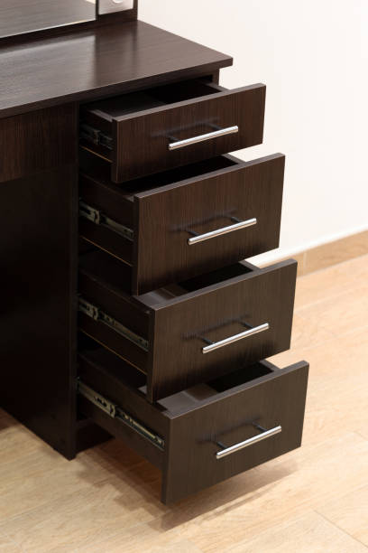 istock Close-up of a black dressing table with an open drawer. 1587422131
