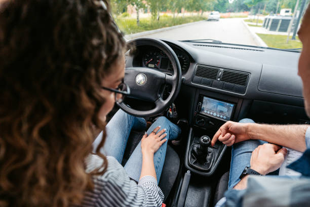 istock Young Woman Having A Driving Lesson With A Male Driving Instructor 1587427681