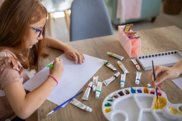 istock Girl drawing at home 1587429363