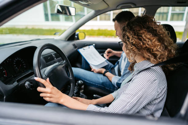 istock Young Woman Taking A Driving Test 1587430319
