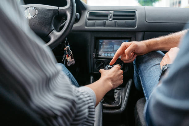 istock Young Woman Having A Driving Lesson With A Male Driving Instructor 1587430948
