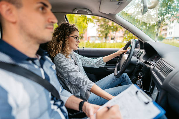 istock Young Woman Taking A Driving Test 1587433744