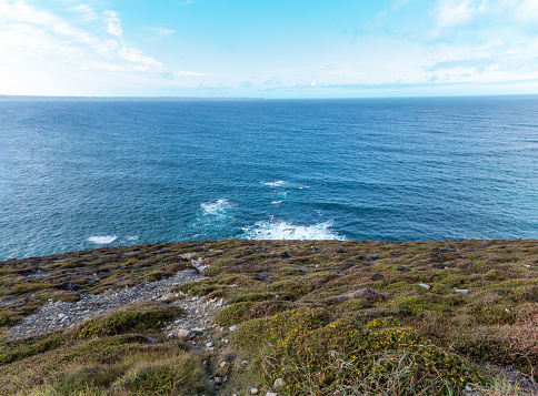 look down the steep coastal slope to and across the Atlantic Ocean. Near Crozon, Morgat and Camaret-sur-Mer, Brittany, France