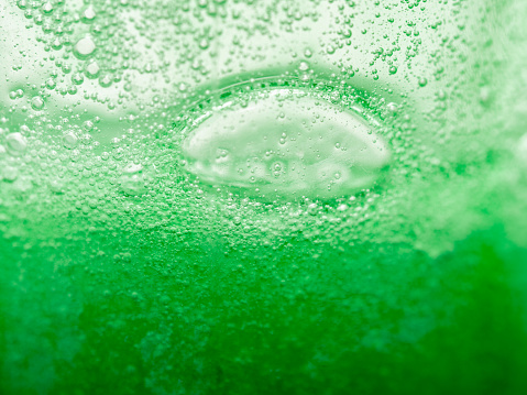 countless small and some larger air bubbles in a thick green liquid