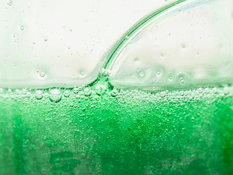 countless small and some larger air bubbles in a thick green liquid