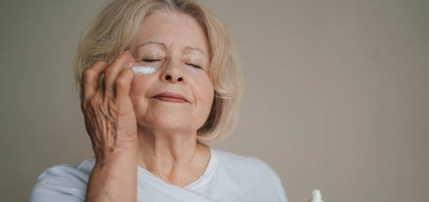 istock Senior woman applying eye patches 1587462158
