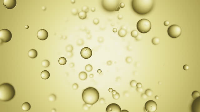 Liquid bubble drops flying on yellow background