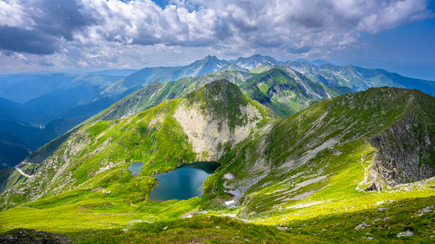 The Capra Lake. Summer landscape of the Fagaras Mountains, Romania. A view from the hiking trail near the Balea Lake and the Transfagarasan Road. The Capra Lake. Summer landscape of the Fagaras Mountains, Romania. A view from the hiking trail near the Balea Lake and the Transfagarasan Road. balea lake romania stock pictures, royalty-free photos & images