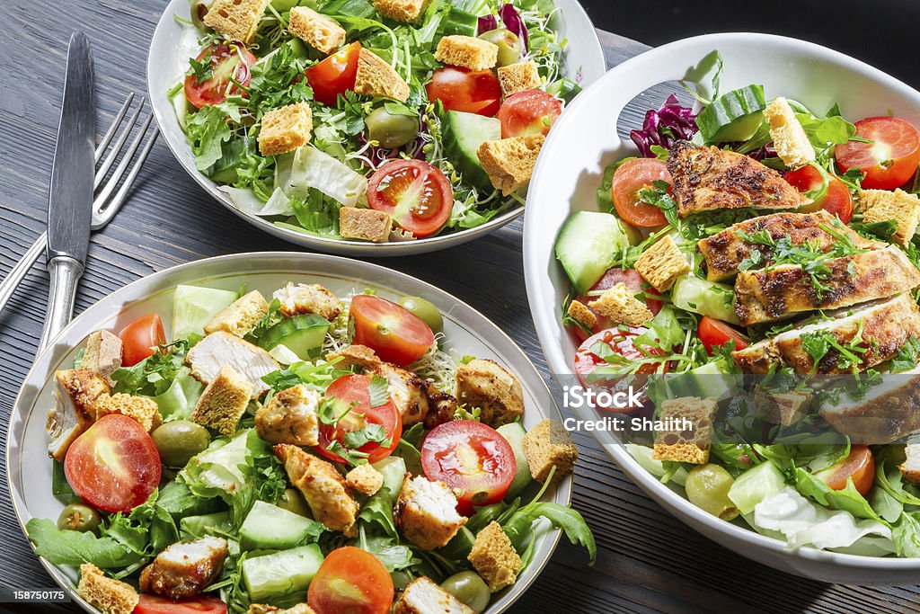 Three healthy salads with vegetables and chicken Three healthy salads with vegetables and chicken. Chicken Salad Stock Photo