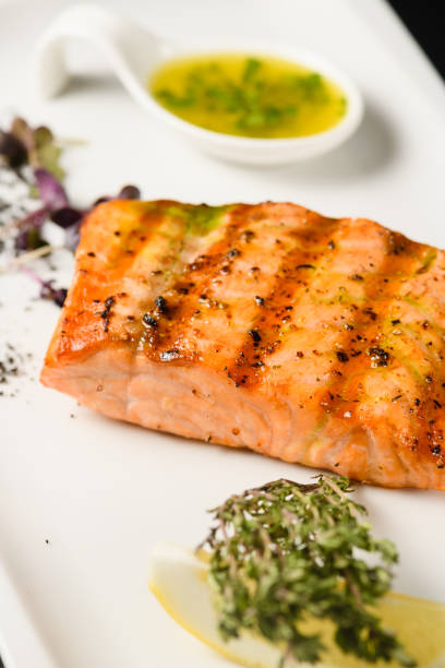 istock Appetizing grilled salmon fillet on a white plate. 1587503115