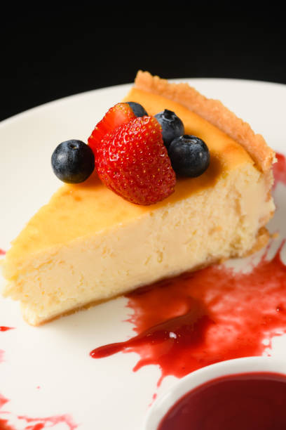 istock Appetizing dessert cheesecake on a white plate. 1587504228