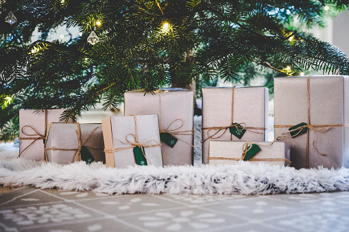 Beautifully wrapped presents under decorated tree