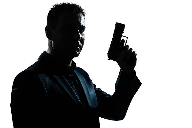 istock silhouette man portrait with gun 158751867