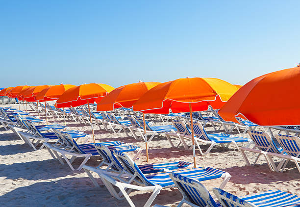 istock Orange umbrellas on the beach 158752731