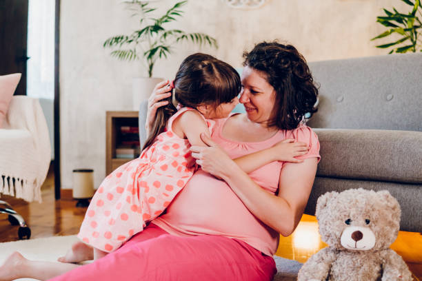 istock A daughter hugs her pregnant mother 1587533418