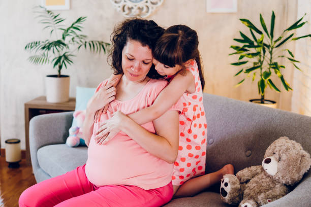 istock A daughter hugs her pregnant mother 1587534618