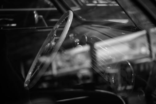 a dashboard from a vintage sports automobile with a retro design and interiors in black and white.