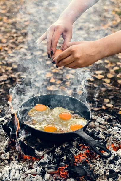 istock fried bacon in a pan over a campfire in the forest 1587544773