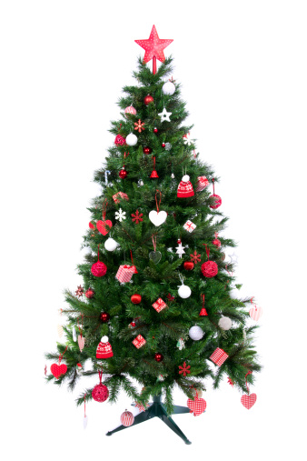 Decorated Christmas tree with patchwork ornament, artificial red star, hearts, hat and small presents for new year isolated on white background