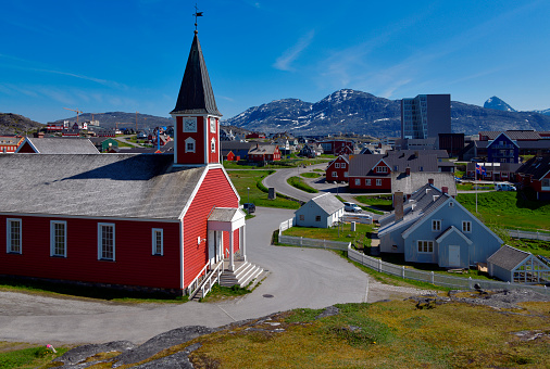 Nuuk / Godthåb, Sermersooq, Greenland: Nuuk Lutheran Cathedral or Church of Our Saviour. Iconic red wooden church with its spire and weather-vane, located by the Colonial Harbor - the oldest district in Nuuk (1849) - head church of the Lutheran Diocese of Greenland.