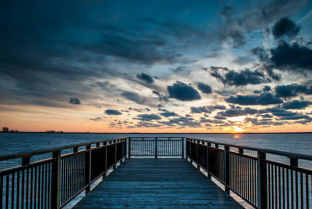 Pier in bay during sunset stock photo