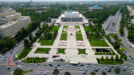 Tashkent, Uzbekistan - May 24, 2021: Aerial view of International Friendship Square in Tashkent city with waving Uzbekistan flag