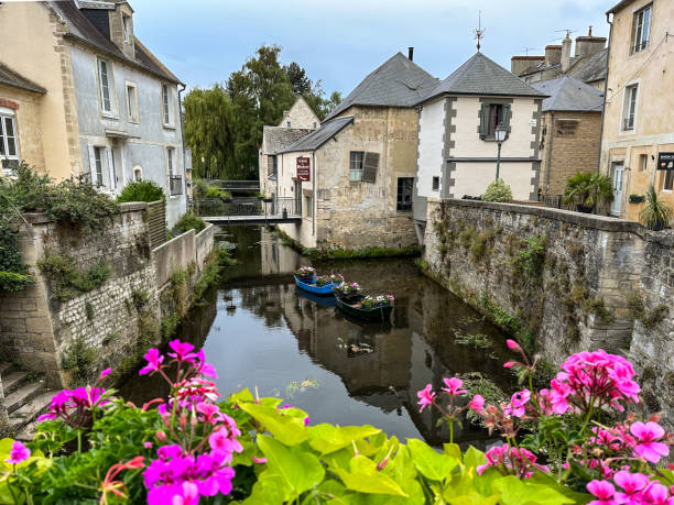 istock Watermill in Bayeux with flowers 1587571157