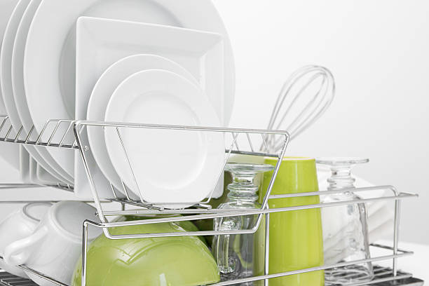 istock Green and white dishes drying on dish rack 158757502