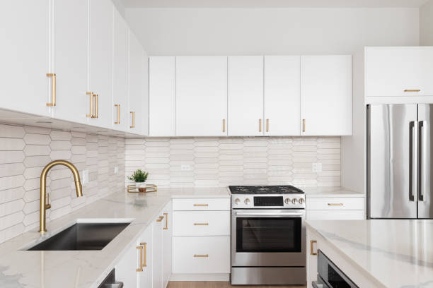istock A kitchen detail with white cabinets and a brown picket tile backsplash. 1587576885
