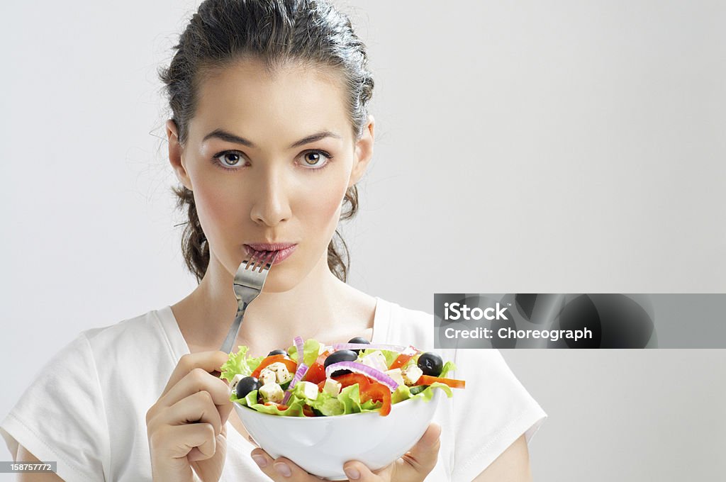 eating healthy food A beautiful girl eating healthy food Beautiful Woman Stock Photo