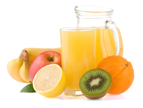 fresh tropical fruits and juice in glass isolated on white background