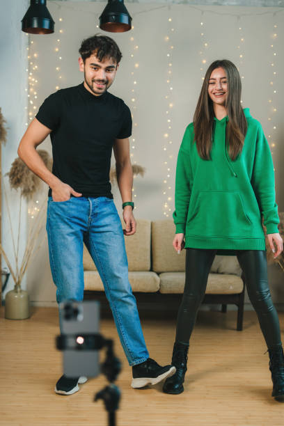 istock Bloggers recording video content in professional creative studio. Social media videoblog 1587600427