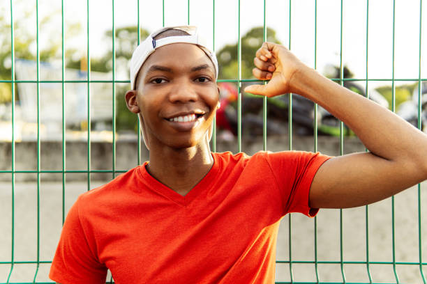 istock Portrait of a cheerful young black man looking at camera. 1587603200