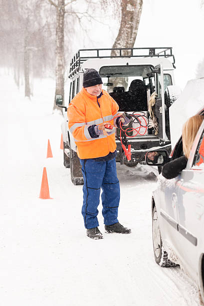 istock Man helping woman with broken car snow 158762244