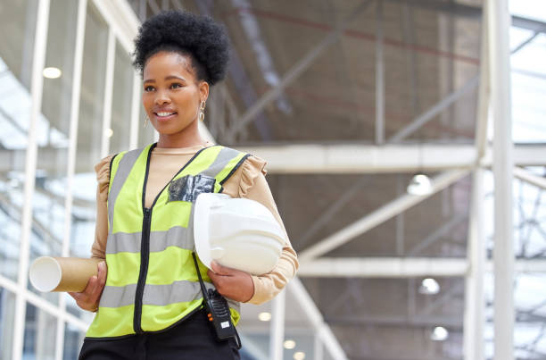istock Black woman, blueprint or architect walking on construction site for project management or inspection. Engineering, thinking or designer with floor plan for architecture, development or innovation 1587634755