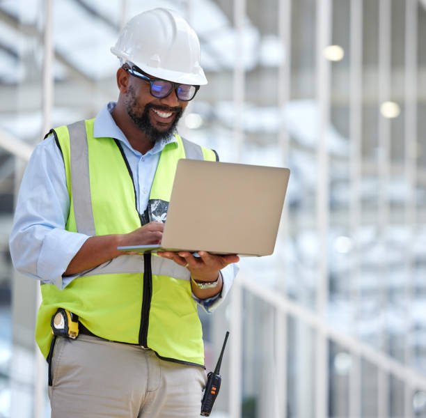 istock Laptop, engineering man and construction worker for online project. management, building progress and floor plan. African person in architecture design on computer for renovation on industry software 1587634758