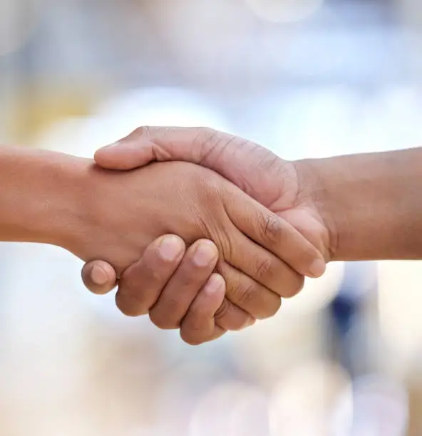 Photo of Closeup, handshake and people meeting for introduction, HR agreement and support of b2b deal, partnership or welcome. Thank you, greeting and shaking hands for hello, networking and trust of success