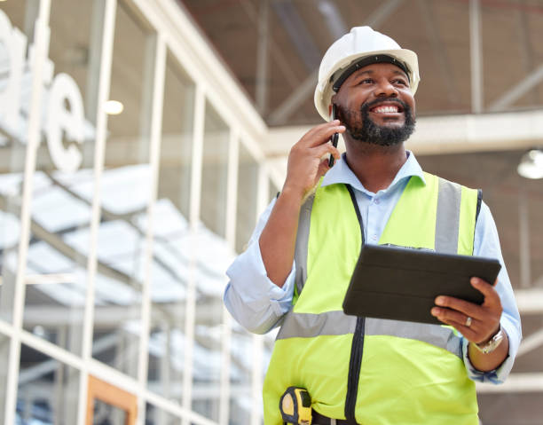 Phone call, black man and engineer with tablet for talking, planning and working on construction project. African architect, mobile technology and happy contractor on internet, email and thinking.