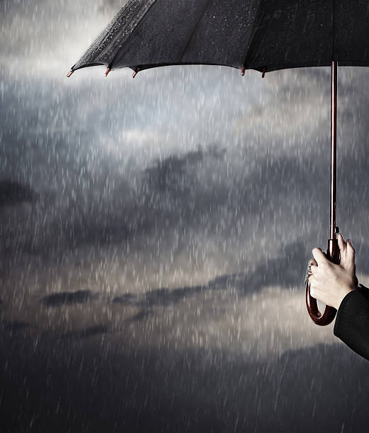 istock Hands holding an umbrella in the rain 158763806