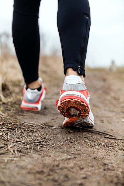 istock Walking or running legs sport shoes 158764183