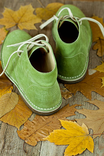 istock green leather boots and yellow leaves 158764640