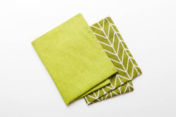 istock top view with green kitchen napkin isolated on table background. Folded cloth for mockup with copy space, Flat lay. Minimal style 1587646712