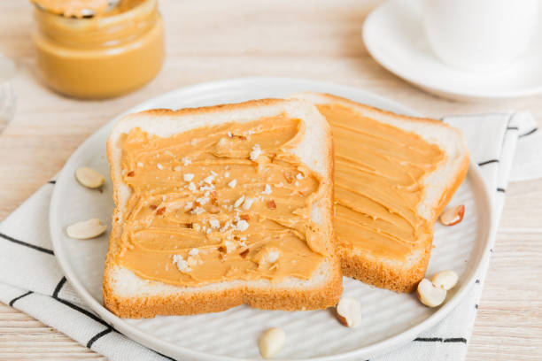Peanut butter sandwiches or toasts on light table background.Breakfast. Vegetarian food. American cuisine top view vith copy space
