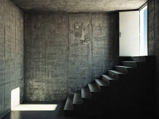Interior room with concrete walls and stairs leading to the exit