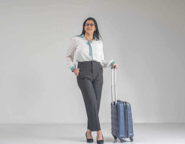 istock Manager with suitcase looking up and standing on white background 1587677095